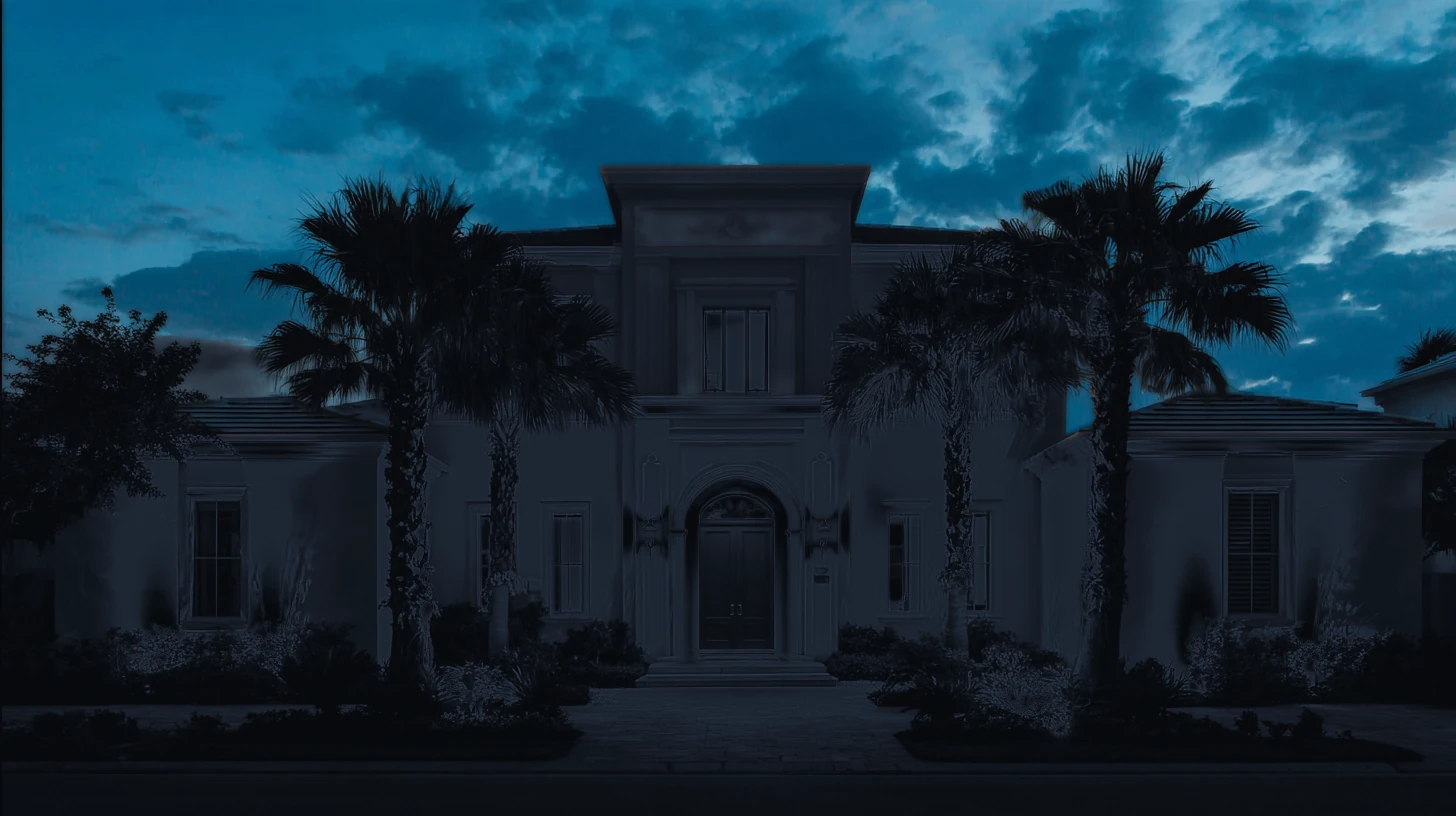 A two-story Southwest Florida home at blue hour seen straight-on, every window and lamp dark during a power outage