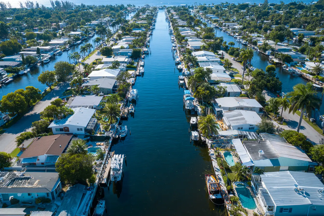 An aerial view of a Southwest Florida canal grid, docks and boat lifts along seawalled waterfront lots
